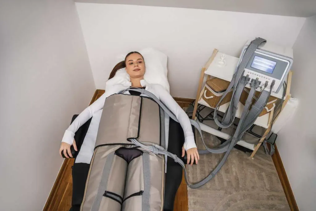Patient receiving lymphatic compression therapy during a wellness session in Central Arkansas.